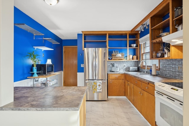 kitchen featuring tasteful backsplash, stainless steel appliances, stainless steel counters, sink, and range hood