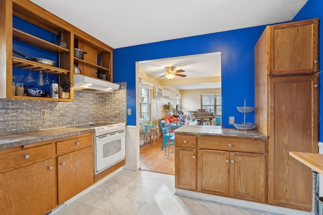 kitchen with electric range, ceiling fan, and backsplash