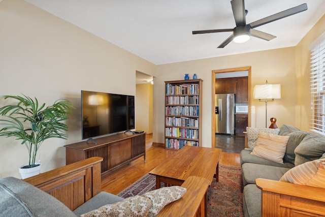 living room featuring ceiling fan and hardwood / wood-style floors