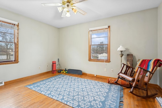 sitting room featuring ceiling fan, plenty of natural light, and hardwood / wood-style flooring