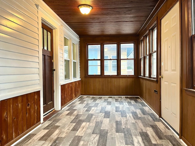 unfurnished sunroom featuring wood ceiling