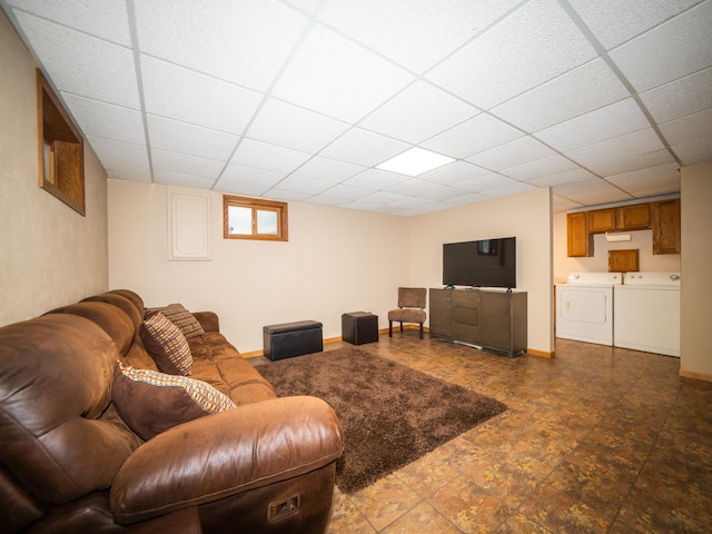 living room featuring washing machine and dryer and a drop ceiling