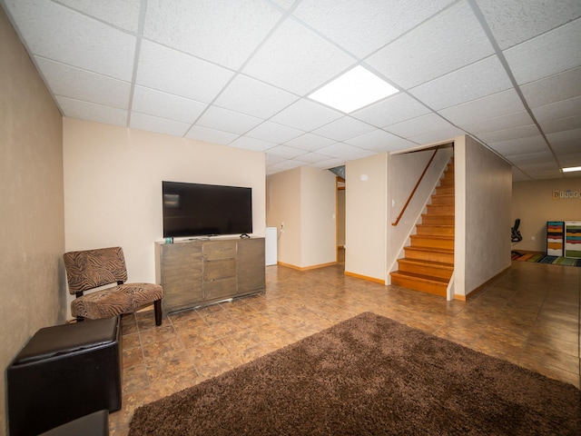 living room featuring a drop ceiling