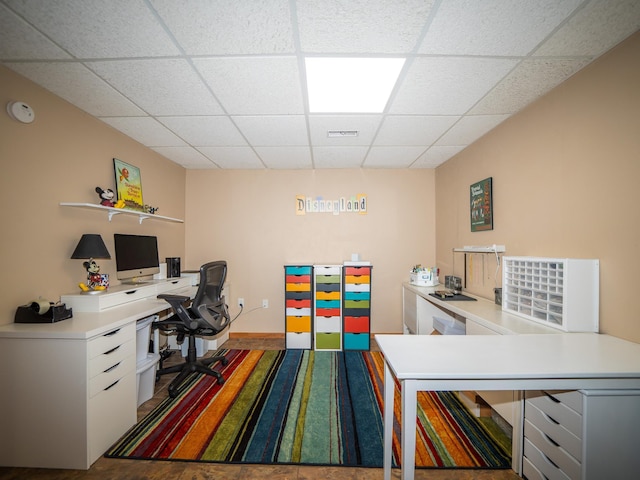 home office with a paneled ceiling