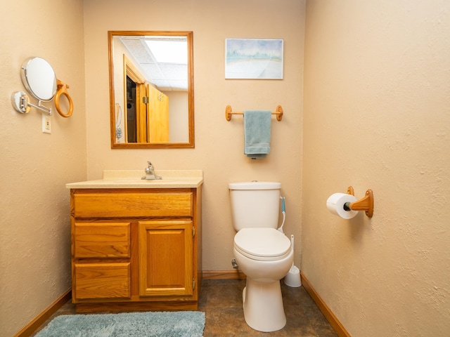 bathroom featuring toilet and vanity