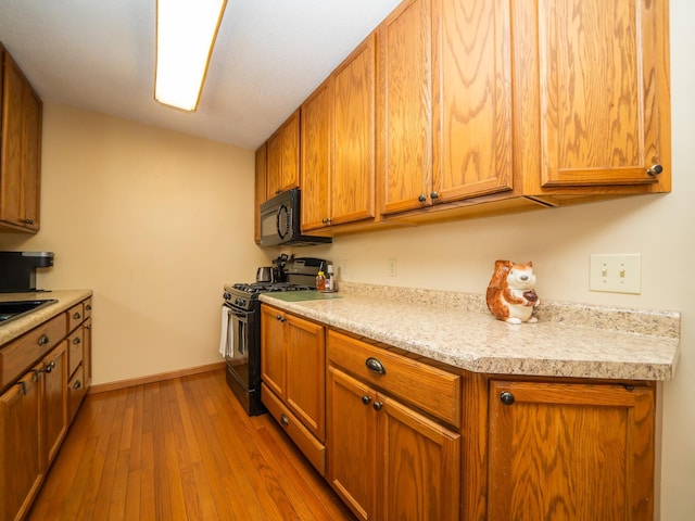 kitchen with black appliances and light wood-type flooring