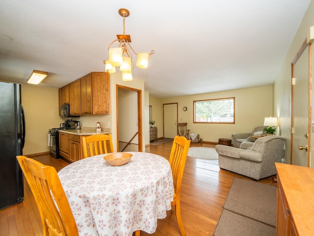 dining room with hardwood / wood-style flooring and a notable chandelier