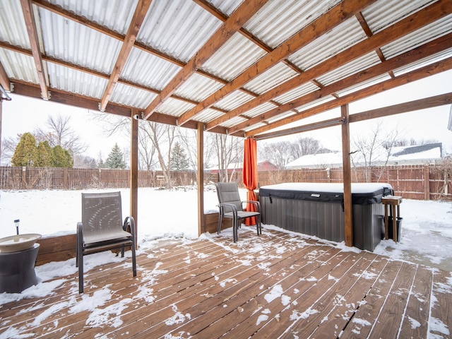 snow covered deck featuring a hot tub