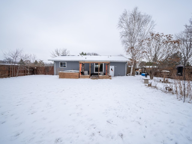 snow covered property featuring a wooden deck