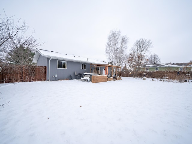 snow covered house with a hot tub