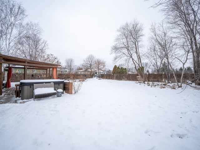 yard covered in snow with a hot tub