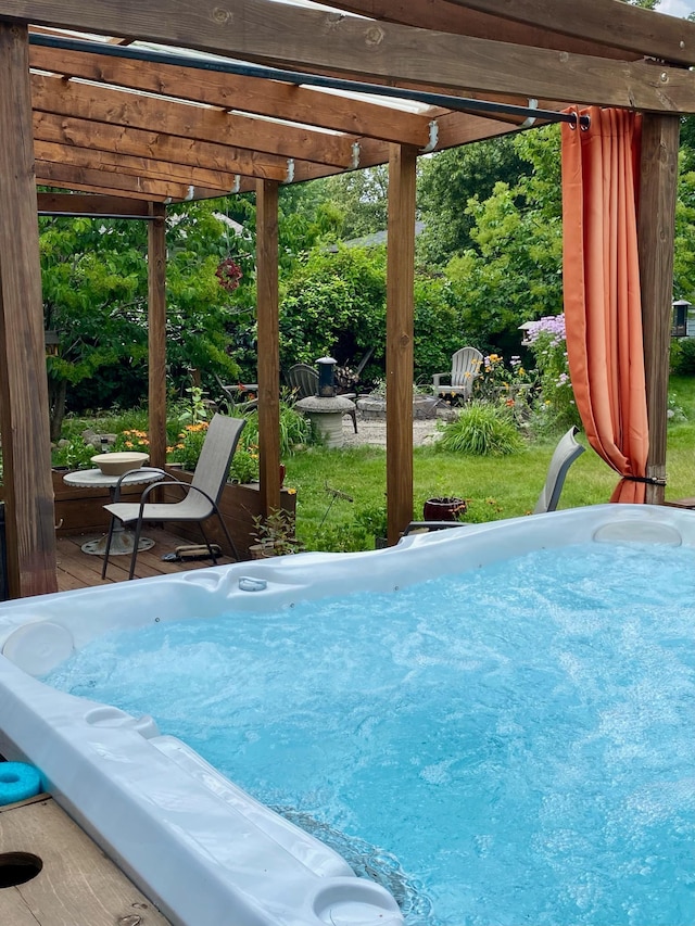 view of pool with a pergola, a hot tub, and a yard