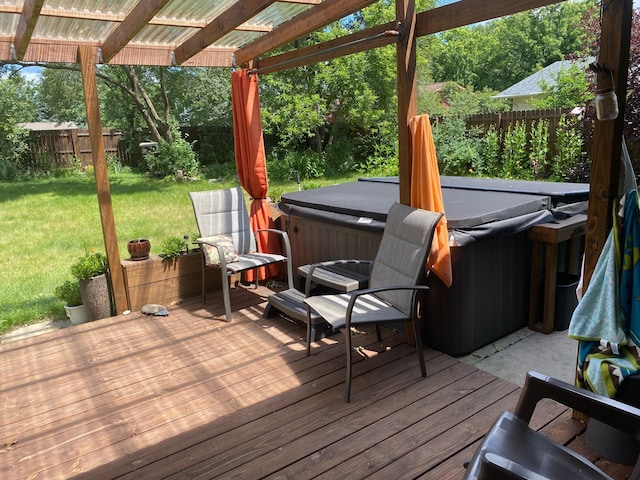 wooden terrace featuring a hot tub, a pergola, and a yard