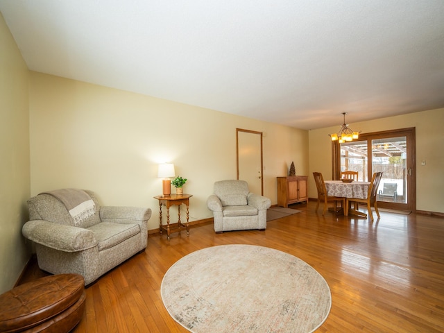 living room featuring an inviting chandelier and hardwood / wood-style flooring