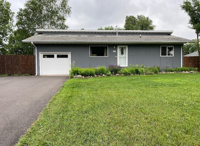 ranch-style home featuring a front lawn and a garage