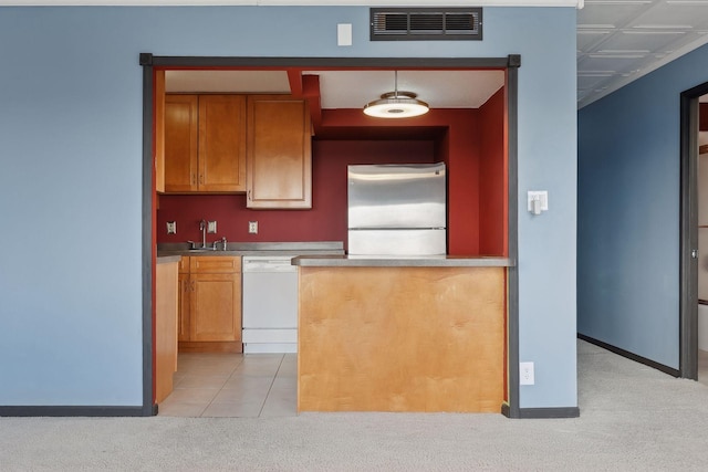 kitchen featuring white dishwasher, light colored carpet, stainless steel fridge, and pendant lighting