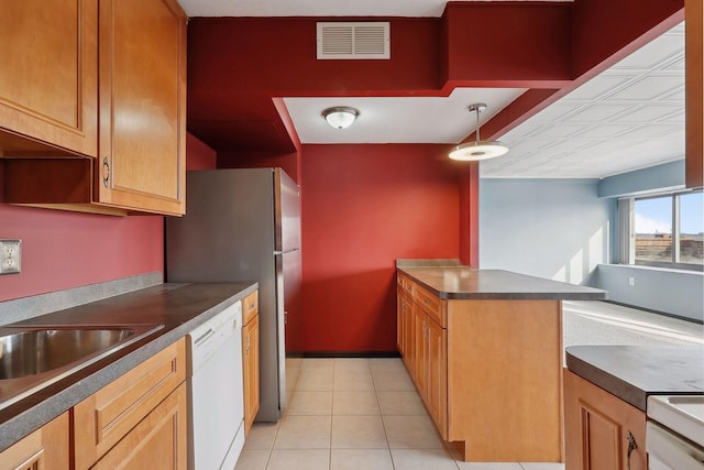 kitchen with hanging light fixtures, light tile patterned flooring, and white dishwasher