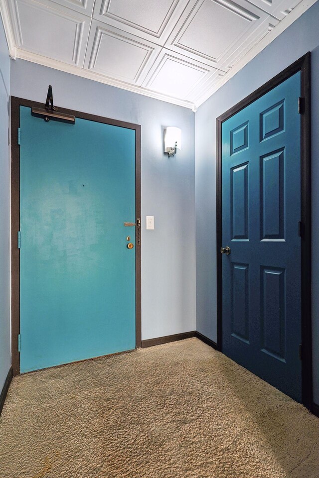 carpeted entryway featuring coffered ceiling