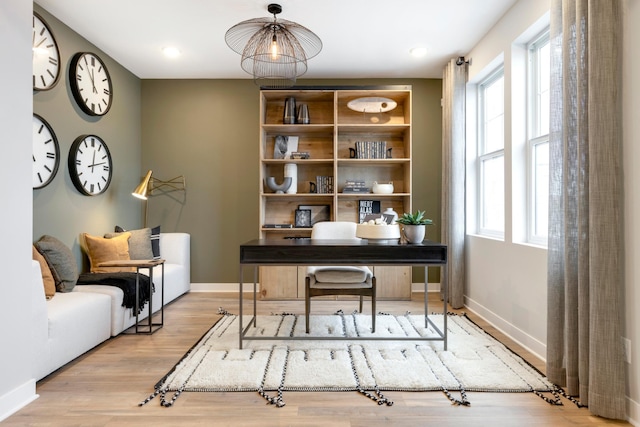 office space featuring a healthy amount of sunlight and light hardwood / wood-style floors