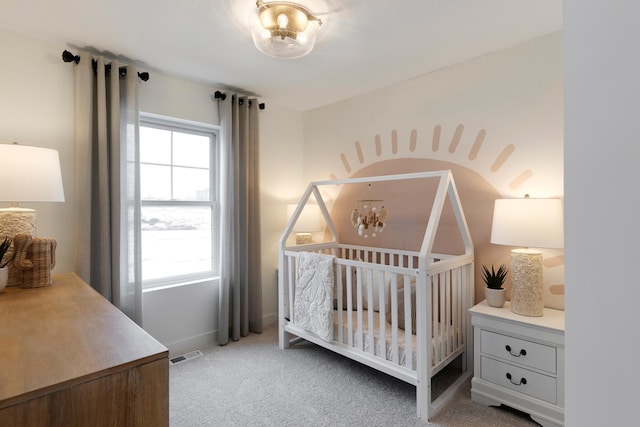 carpeted bedroom with a nursery area