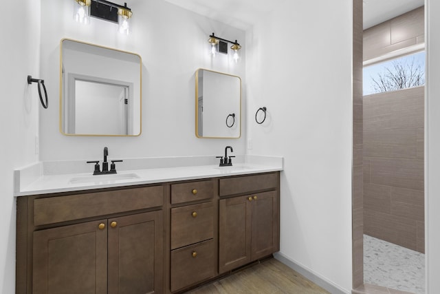 bathroom with vanity, a shower, and wood-type flooring