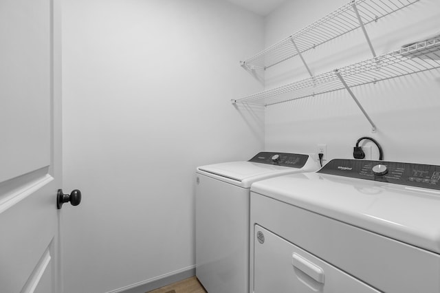 washroom featuring washer and dryer and hardwood / wood-style floors