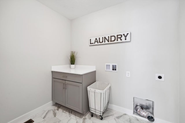 laundry area with hookup for an electric dryer, washer hookup, and cabinets