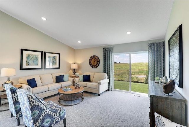 carpeted living room with vaulted ceiling