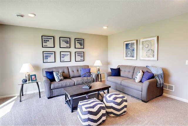 living room featuring light carpet and a textured ceiling