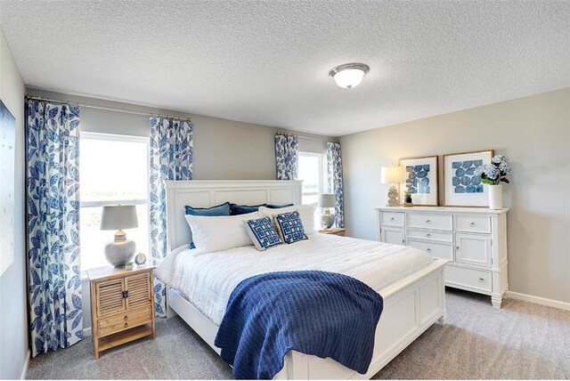 carpeted bedroom with a textured ceiling