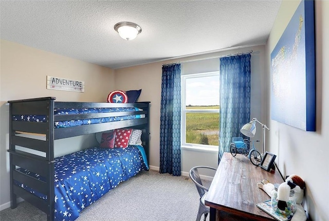 bedroom with carpet flooring and a textured ceiling