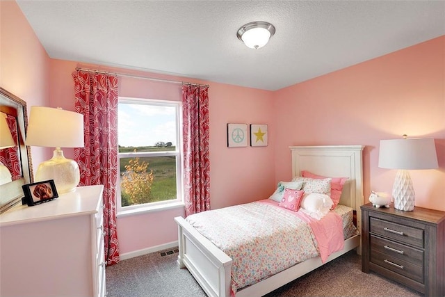 carpeted bedroom with a textured ceiling