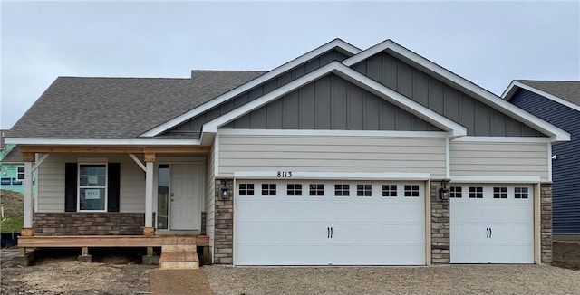 craftsman house featuring covered porch and a garage