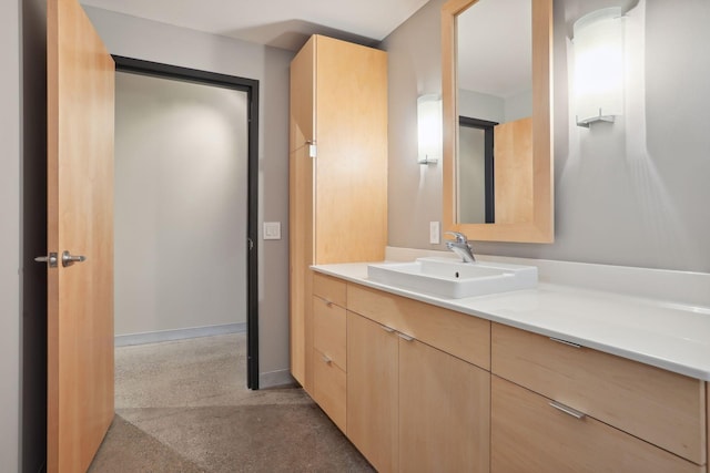 bathroom with baseboards and vanity