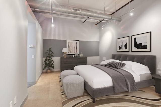 bedroom with a high ceiling, baseboards, and visible vents