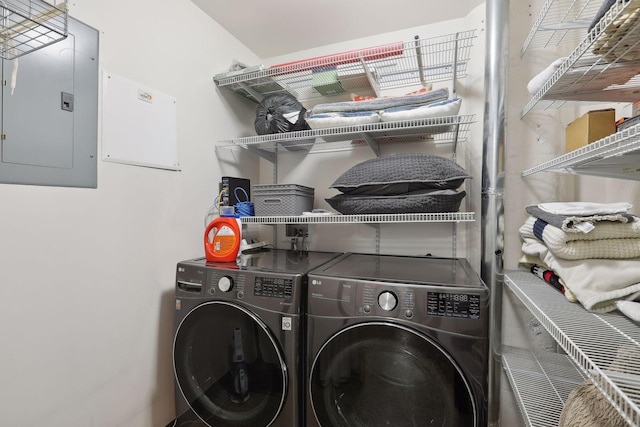 washroom featuring washing machine and clothes dryer, laundry area, and electric panel