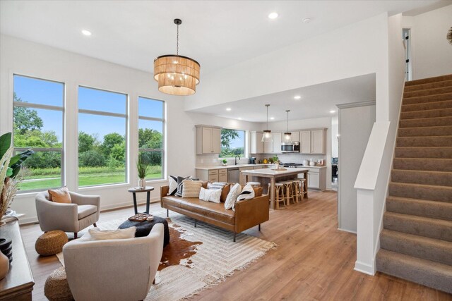 living room featuring sink and light hardwood / wood-style flooring