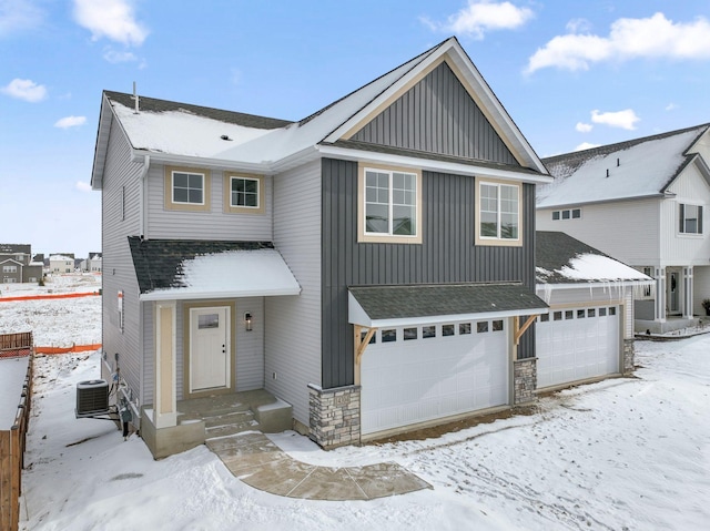 view of front of home featuring a garage and central AC