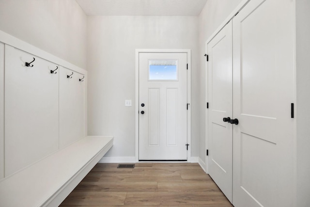 mudroom with light hardwood / wood-style floors