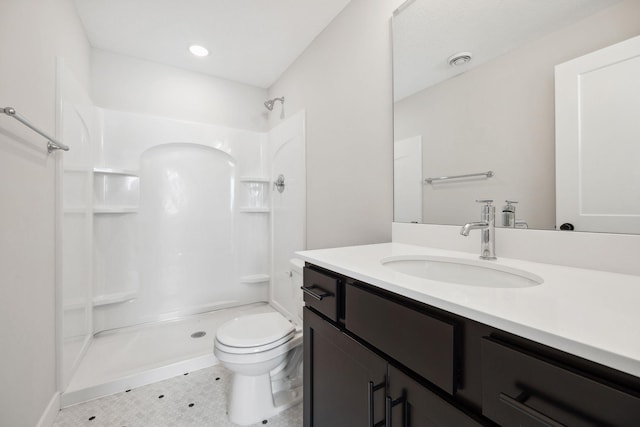 bathroom featuring vanity, tile patterned floors, toilet, and walk in shower