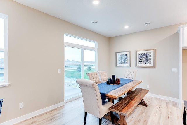 dining space with light hardwood / wood-style flooring