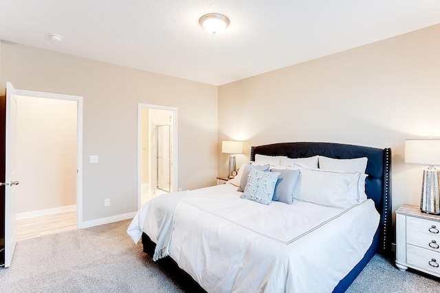 bedroom featuring carpet flooring and connected bathroom