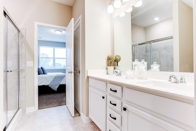 bathroom featuring tile patterned flooring, vanity, and a shower with shower door