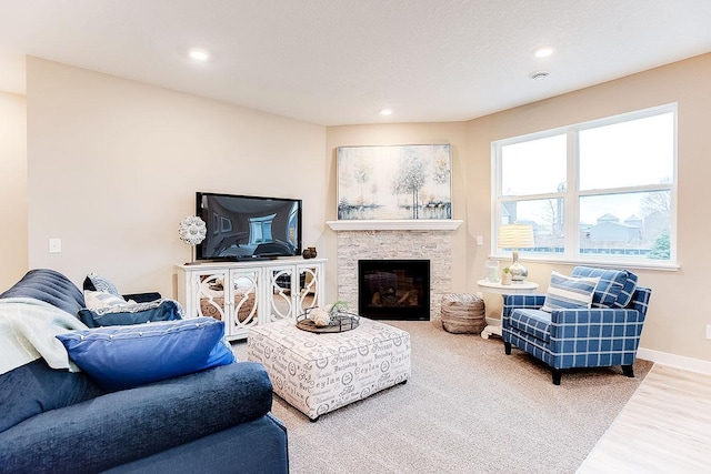 living room with hardwood / wood-style flooring and a fireplace