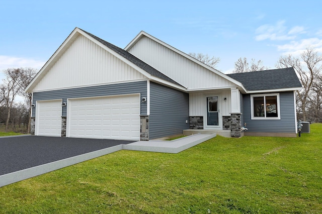 single story home featuring a front lawn, driveway, stone siding, roof with shingles, and a garage