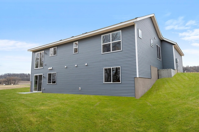rear view of house with a yard