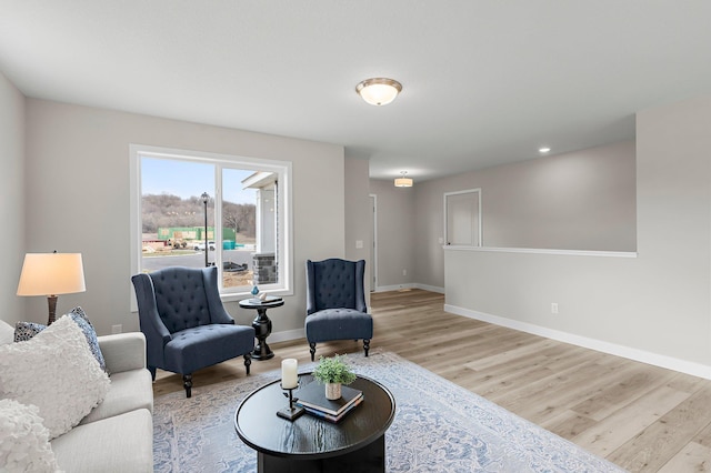 sitting room featuring baseboards and wood finished floors