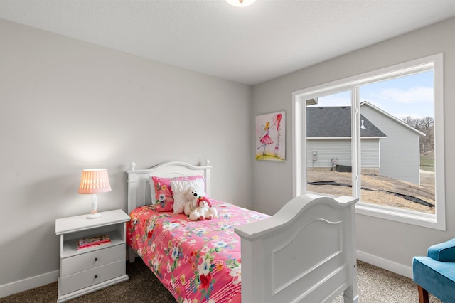 bedroom with baseboards and carpet floors