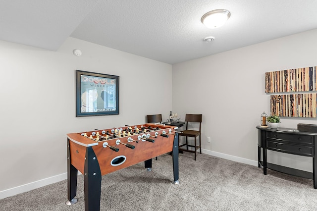 game room featuring baseboards, carpet floors, and a textured ceiling