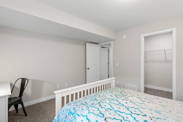 carpeted bedroom with visible vents and baseboards